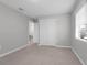 Bedroom featuring tile flooring, window with blinds, neutral walls, and closet at 654 Romano Ave, Orlando, FL 32807