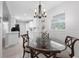 Bright dining room with a view into the kitchen, complemented by a modern light fixture at 654 Romano Ave, Orlando, FL 32807