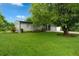 Charming single-story home featuring a lush green lawn and mature trees for ample shade and curb appeal at 654 Romano Ave, Orlando, FL 32807