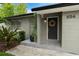 A welcoming entrance adorned with a wreath, complemented by well-maintained landscaping at 654 Romano Ave, Orlando, FL 32807