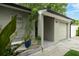 Front exterior of home with garage, landscaped entrance, and freshly painted exterior at 654 Romano Ave, Orlando, FL 32807