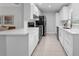 Modern kitchen with white cabinets, stainless steel appliances, and ample counter space at 654 Romano Ave, Orlando, FL 32807