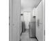 Convenient laundry room featuring modern washer and dryer units, storage cabinets, and tile flooring at 654 Romano Ave, Orlando, FL 32807