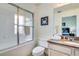 Inviting bathroom featuring a shower-tub combo with sliding glass doors and white tiling next to a single sink vanity at 962 Park Terrace Cir, Kissimmee, FL 34746