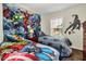 Themed ' bedroom featuring beds adorned with superhero designs and matching wall decor for a playful atmosphere at 962 Park Terrace Cir, Kissimmee, FL 34746