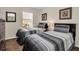 Cozy bedroom featuring two beds with striped gray comforters, natural light, and tasteful artwork for a welcoming atmosphere at 962 Park Terrace Cir, Kissimmee, FL 34746