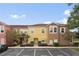 Attractive townhome featuring a colorful facade and well-manicured landscaping creating an inviting curb appeal at 962 Park Terrace Cir, Kissimmee, FL 34746