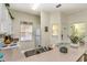 Bright kitchen features neutral countertops, white cabinets, modern appliances, and a stainless steel sink at 962 Park Terrace Cir, Kissimmee, FL 34746