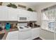 Bright kitchen features sleek countertops, white cabinets and appliances, with a decorative backsplash at 962 Park Terrace Cir, Kissimmee, FL 34746