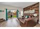 Inviting living room with a wood-paneled accent wall and sliding glass doors leading to the patio at 962 Park Terrace Cir, Kissimmee, FL 34746