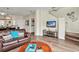 Comfortable living room includes convenient access to the staircase, laundry area, and kitchen for modern living at 962 Park Terrace Cir, Kissimmee, FL 34746