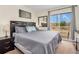 Comfortable main bedroom featuring a queen-size bed, a private balcony, and a neutral color scheme for relaxation at 962 Park Terrace Cir, Kissimmee, FL 34746
