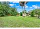 Expansive backyard featuring lush greenery and mature trees at 1013 W 20Th St, Sanford, FL 32771