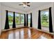Bright bedroom with beautiful hardwood floors, large windows, and elegant black curtains at 1013 W 20Th St, Sanford, FL 32771