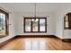 Open dining room featuring hardwood floors, classic trim, and large window for natural light at 1013 W 20Th St, Sanford, FL 32771
