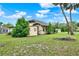 Exterior view of the home showing the side yard and detached garage at 1013 W 20Th St, Sanford, FL 32771