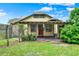 Charming home with red door, covered porch, and well-maintained lawn at 1013 W 20Th St, Sanford, FL 32771