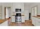 Efficient kitchen with stainless steel appliances, white cabinetry, and terra cotta tile flooring at 1013 W 20Th St, Sanford, FL 32771