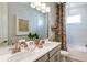 Well-lit bathroom with double sinks, modern fixtures, and decorative touches at 1023 Ladyfish Trl, St Cloud, FL 34771