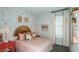 Charming bedroom with unique wall decor, cozy bedding, and stylish bedside accents at 1023 Ladyfish Trl, St Cloud, FL 34771