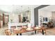 Open-concept dining room with a view into the modern kitchen and a connected living space at 1023 Ladyfish Trl, St Cloud, FL 34771