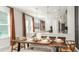 Elegant dining room featuring modern lighting, a rustic wooden table, and backyard view at 1023 Ladyfish Trl, St Cloud, FL 34771
