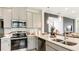 Well-equipped kitchen featuring modern appliances, ample countertop space, and overhead lighting at 1023 Ladyfish Trl, St Cloud, FL 34771