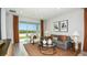 Cozy living room showcasing stylish furniture, natural light, and a view of the outdoor patio at 1023 Ladyfish Trl, St Cloud, FL 34771