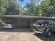 A single story home with a covered carport and two cars in the driveway at 1807 N Powers Dr, Orlando, FL 32818