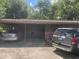 A single story home with a covered carport and two cars in the driveway at 1807 N Powers Dr, Orlando, FL 32818