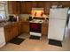 Functional kitchen with ample cabinet space, appliances, and neutral tile flooring at 1807 N Powers Dr, Orlando, FL 32818
