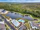 Aerial view of neighborhood featuring a lake, pool, trees, and sidewalks at 1859 Island Village Way, Kissimmee, FL 34747
