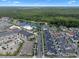 Scenic aerial view of a community featuring a mix of housing and commercial near a lake at 1859 Island Village Way, Kissimmee, FL 34747