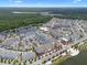 Aerial view showcases a vibrant community with lakefront access, diverse housing, and commercial spaces at 1859 Island Village Way, Kissimmee, FL 34747
