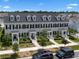 Aerial view of a well-maintained townhome with mature trees and landscaping at 1859 Island Village Way, Kissimmee, FL 34747