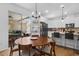Sunlit dining area with access to outdoor patio and an open kitchen concept at 1859 Island Village Way, Kissimmee, FL 34747