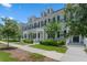 Street view of townhomes with dormer windows, black shutters and green lawns at 1859 Island Village Way, Kissimmee, FL 34747