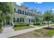 Sidewalk view of townhomes with white trim, black shutters and manicured landscaping at 1859 Island Village Way, Kissimmee, FL 34747