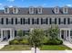 Attractive townhome with black shutters, dormer windows and manicured greenery at 1859 Island Village Way, Kissimmee, FL 34747