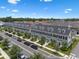 Charming townhomes with well-maintained landscaping and a tree-lined street at 1859 Island Village Way, Kissimmee, FL 34747