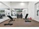 Well-equipped gym area featuring weight racks, benches, mirrors, and modern exercise equipment at 1859 Island Village Way, Kissimmee, FL 34747