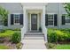 Inviting front entryway with classic white columns and manicured landscaping at 1859 Island Village Way, Kissimmee, FL 34747