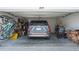 Organized two-car garage featuring ample storage space, with a car parked inside at 1859 Island Village Way, Kissimmee, FL 34747