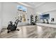 Exercise room with bikes, weights, and mirrored wall with a TV screen at 1859 Island Village Way, Kissimmee, FL 34747