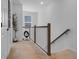 Bright upstairs hallway with natural light and stylish railing, showcasing a clean and modern aesthetic at 1859 Island Village Way, Kissimmee, FL 34747