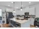 Well-lit kitchen with a large island, modern appliances, and sleek countertops at 1859 Island Village Way, Kissimmee, FL 34747