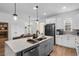 Spacious kitchen with a large island, modern appliances, and a view into the dining area at 1859 Island Village Way, Kissimmee, FL 34747