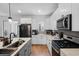 Modern kitchen with stainless steel appliances, an island with seating, and contemporary finishes at 1859 Island Village Way, Kissimmee, FL 34747