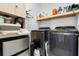 Well-organized laundry room with modern washer and dryer, ample storage, and a convenient folding area at 1859 Island Village Way, Kissimmee, FL 34747