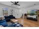 Bright living room with a blue sectional, natural light, and modern decor at 1859 Island Village Way, Kissimmee, FL 34747